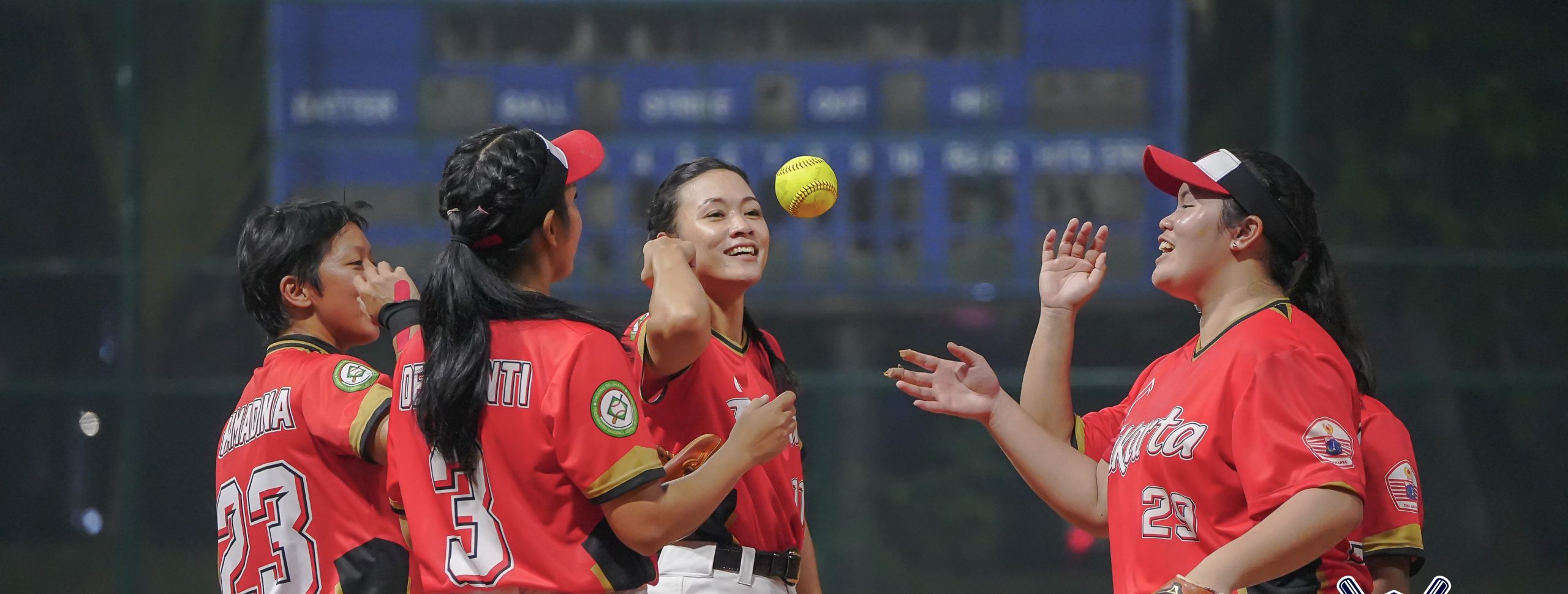 Woman in red baseball jersey